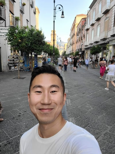 Image of veterans coding scholarship recipient Jin smiling at the camera.